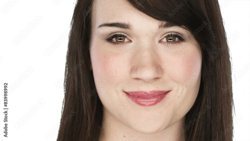 Woman smiles into the camera on a white background Woman smiles into the camera on a white background