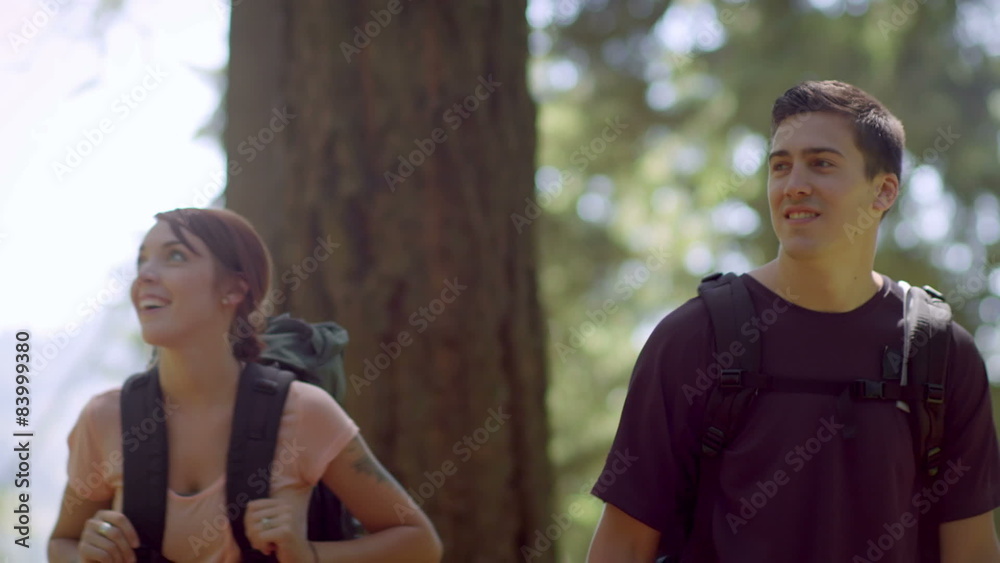 Fit and healthy young couple hiking through park Fit and healthy young couple hiking through park