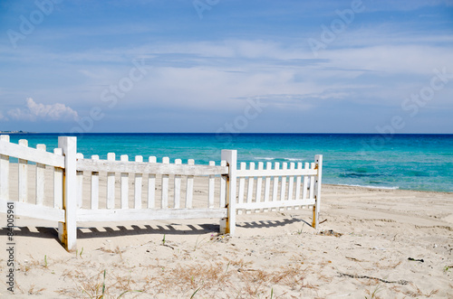 white fence on the beach with blue sea © Daniele Depascale