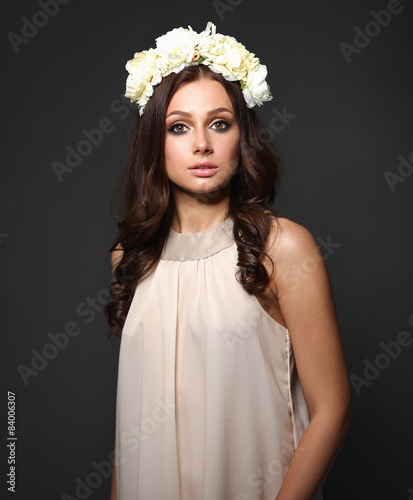 Portrait of a beautiful woman with flowers in her hair. Fashion