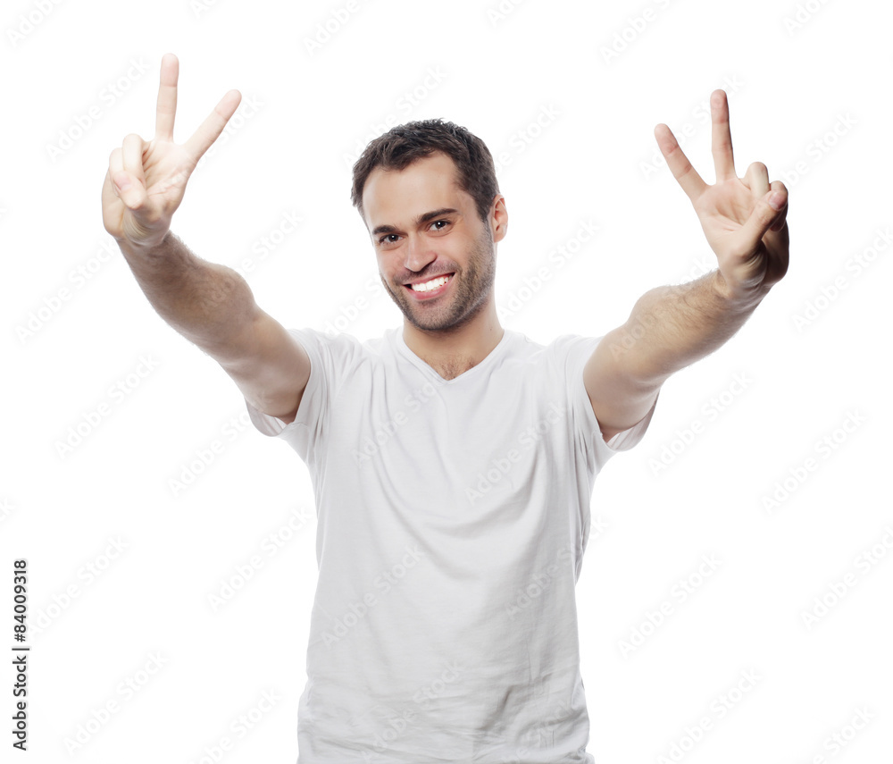 young casual man showing the victory gesture young casual man showing the victory gesture