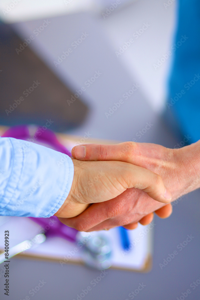 Doctor shakes hands with a patient 