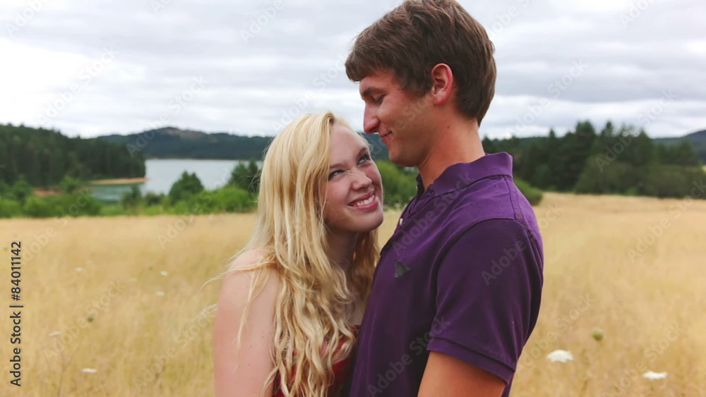 Young couple embrace in a golden field. Young couple embrace in a golden field.