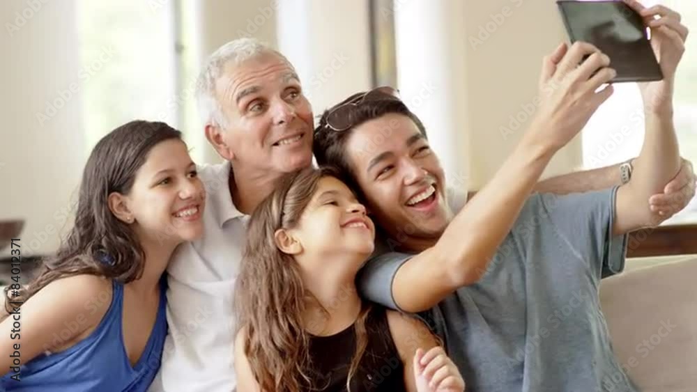 Grandfather using a tablet computer to take pictures with grandchildren Grandfather using a tablet computer to take pictures with grandchildren
