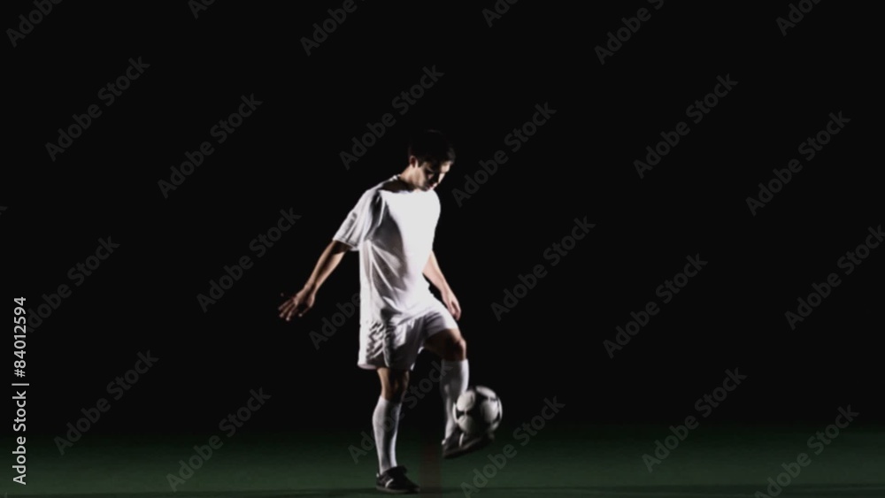 A soccer player receives the ball with his chest and then bicycle kicks it out A soccer player receives the ball with his chest and then bicycle kicks it out