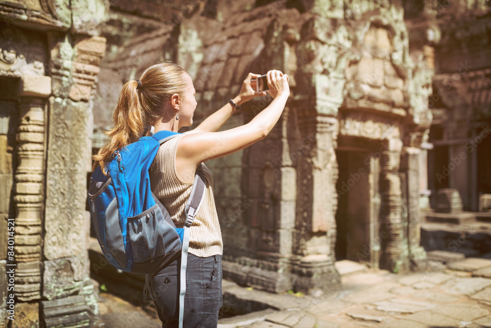 Tourist with smartphone in Preah Khan temple in Angkor, Cambodia