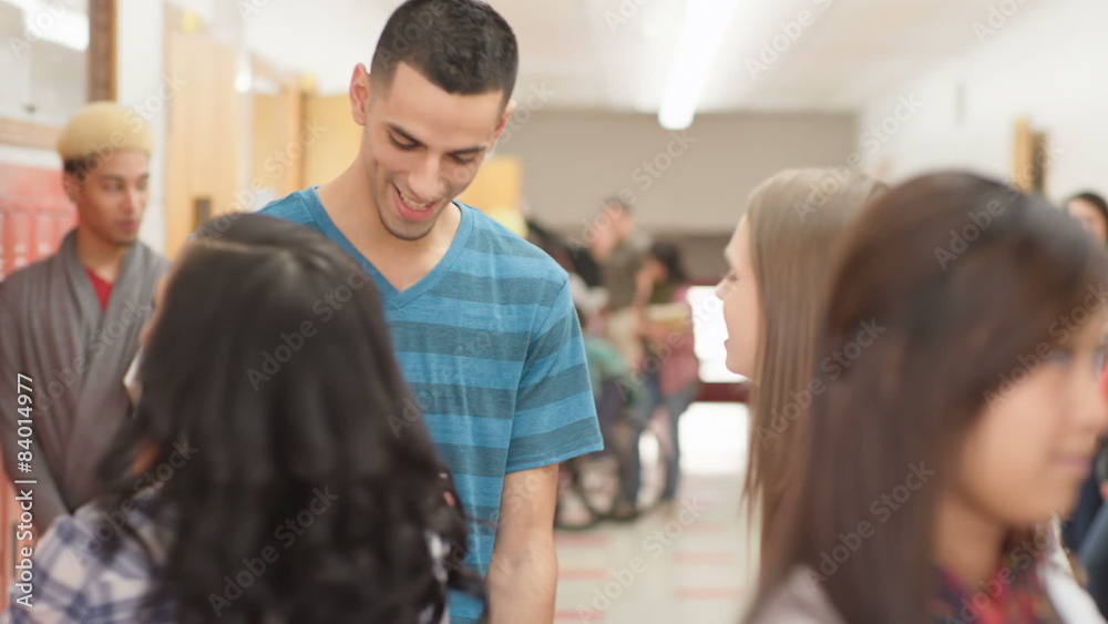 Groups of students talk as they stand in the hallway between classes Groups of students talk as they stand in the hallway between classes