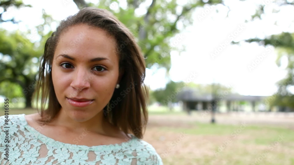Black woman smiles in a park Black woman smiles in a park