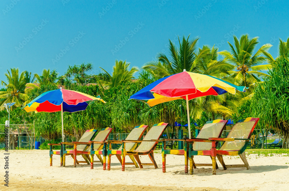 Exotic sandy beach with sun umbrellas and chairs