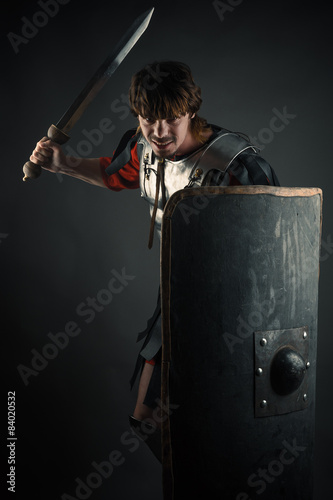 young warrior with a sword and shield in hand