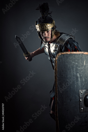 brutal Roman legionary with sword and shield in hands
