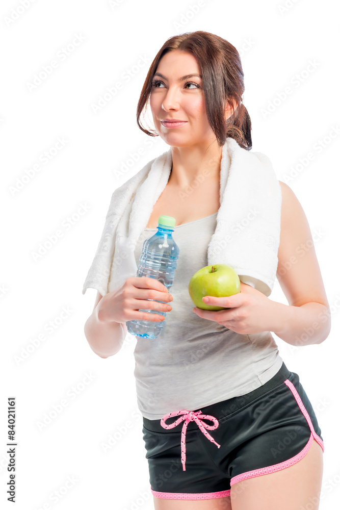 beautiful thoughtful girl holding an apple and a bottle of water beautiful thoughtful girl holding an apple and a bottle of water