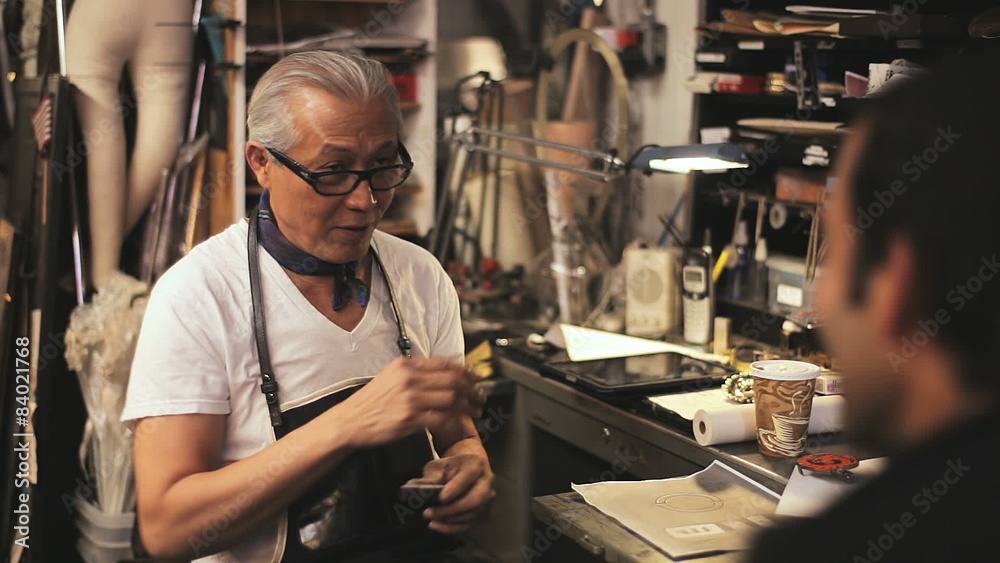 A master craftsman teaches a student hands-on lessons A master craftsman teaches a student hands-on lessons