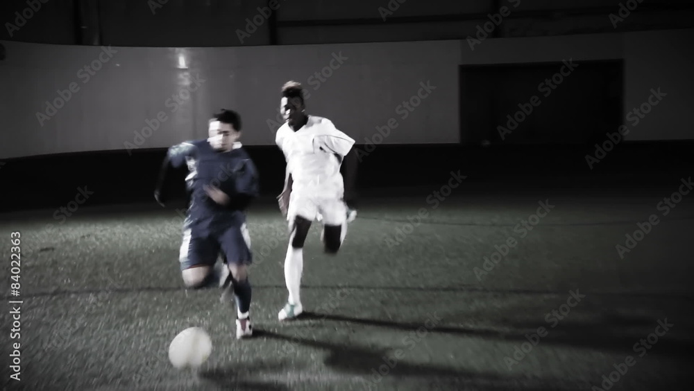 Two soccer players run down the field with the ball Two soccer players run down the field with the ball
