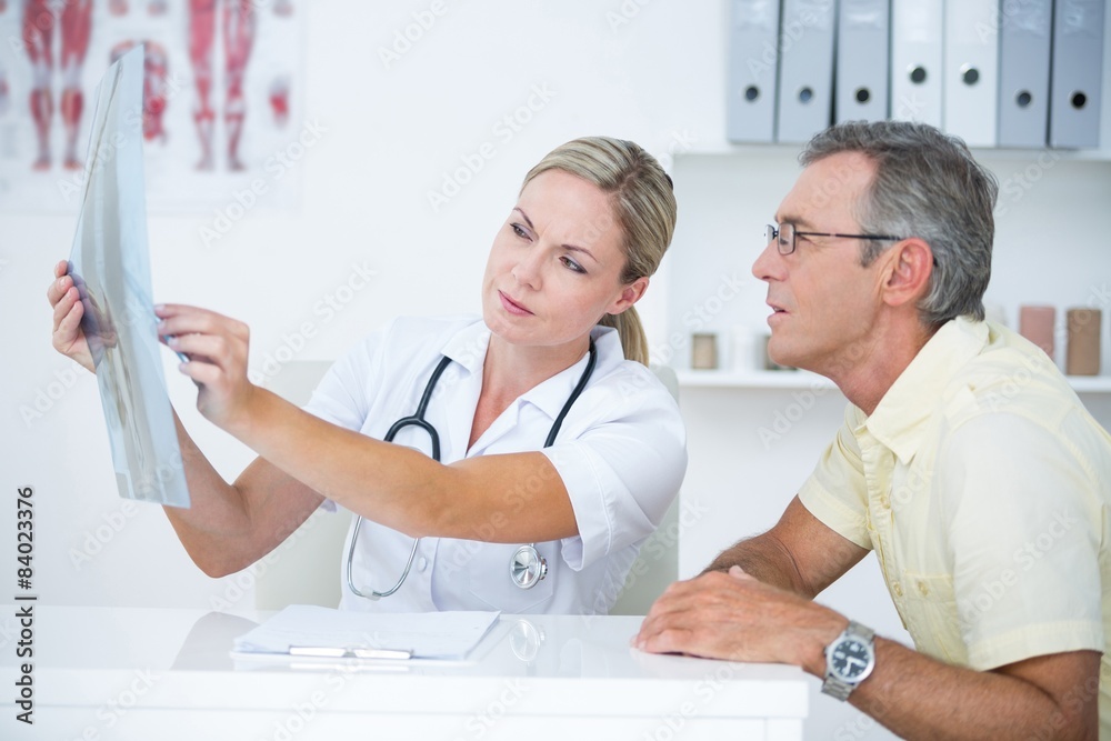 Fototapeta premium Doctor showing X rays to her patient