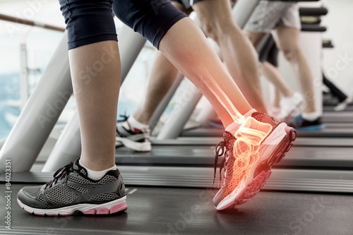 Highlighted ankle of woman on treadmill photo