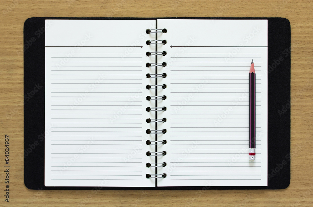 blank spiral notebook and pencil on wood background blank spiral notebook and pencil on wood background