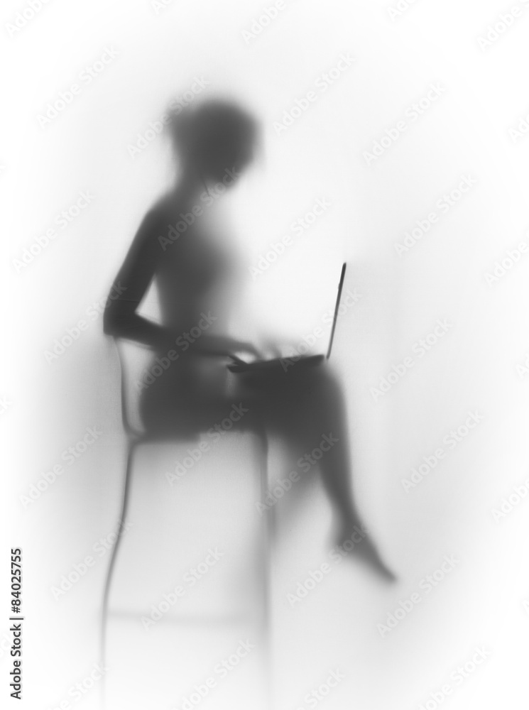 Naklejka premium Silhouette of a pretty, slim woman with laptop and chair