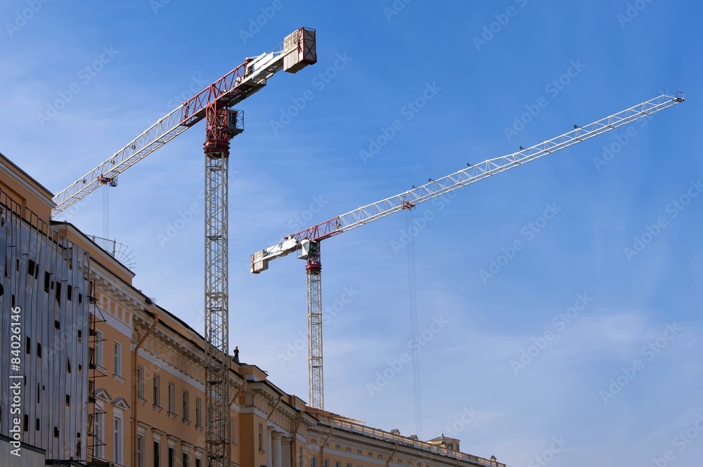 Two high-rise construction cranes