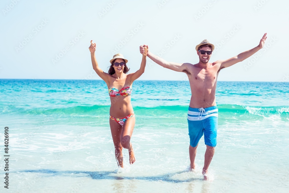 happy couple running on the sea 