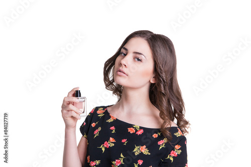 young woman spraying the perfume