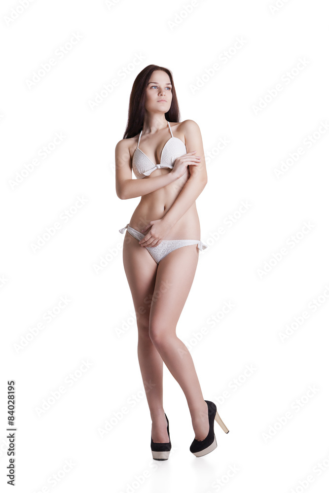 Fototapeta premium Portrait of a beautiful brunette girl wearing white bikini