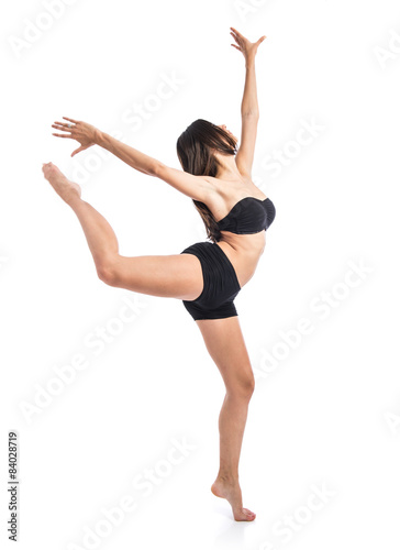 Young ballet dancer posing over white background