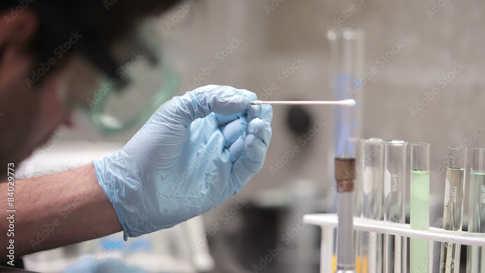 A university student conducts experiments during a chemistry lab class