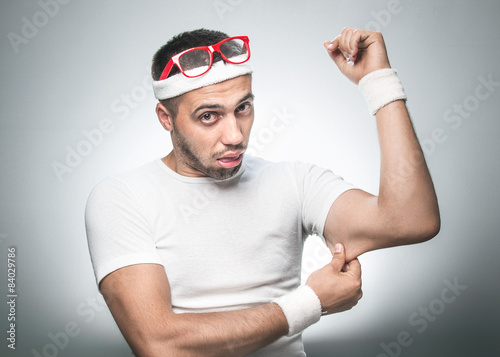 фотографія Funny man testing the flabby muscle under her arm - triceps