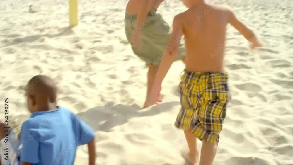 Kids playing soccer on a beach in Brazil Kids playing soccer on a beach in Brazil