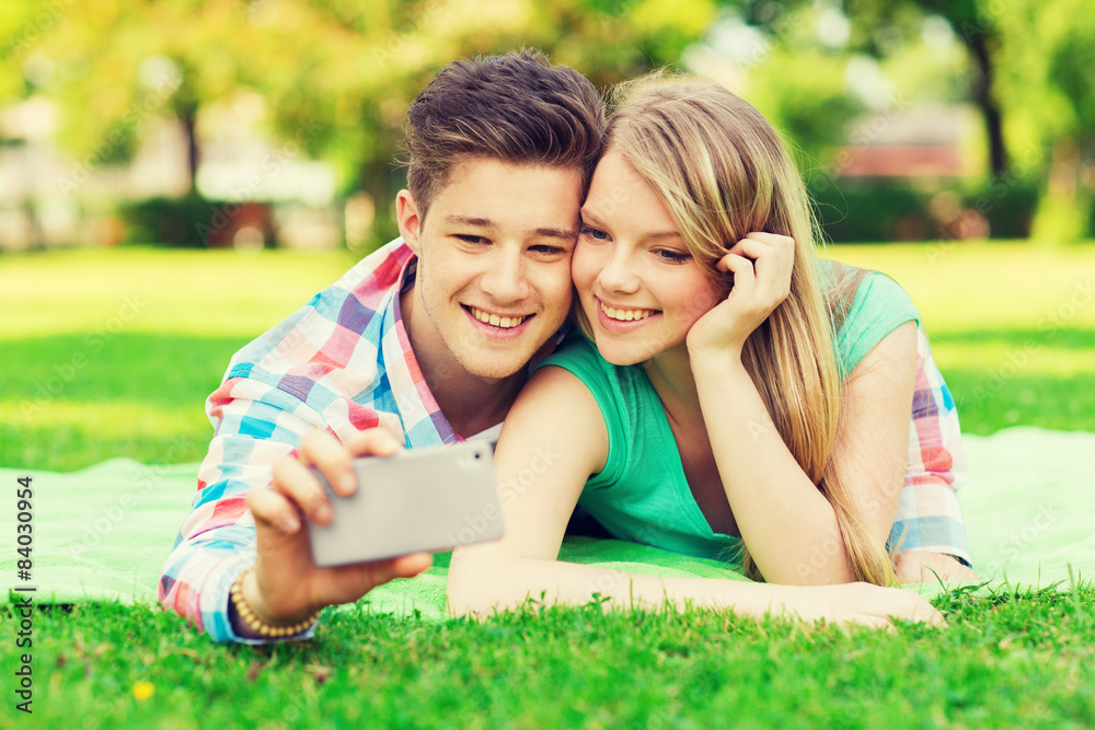 smiling couple making selfie in park smiling couple making selfie in park