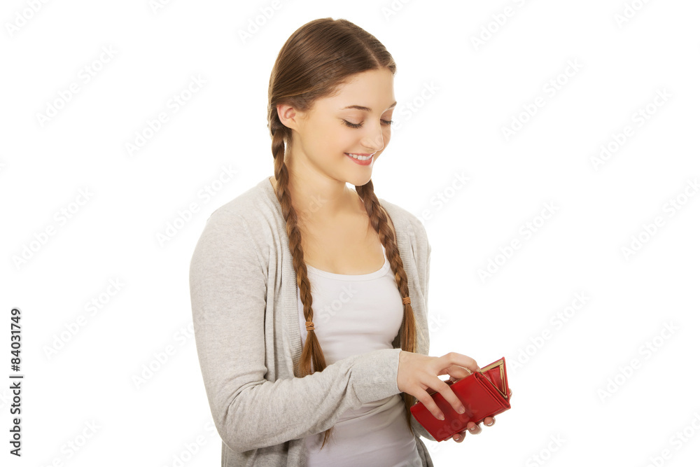 Happy teen woman with a wallet.
