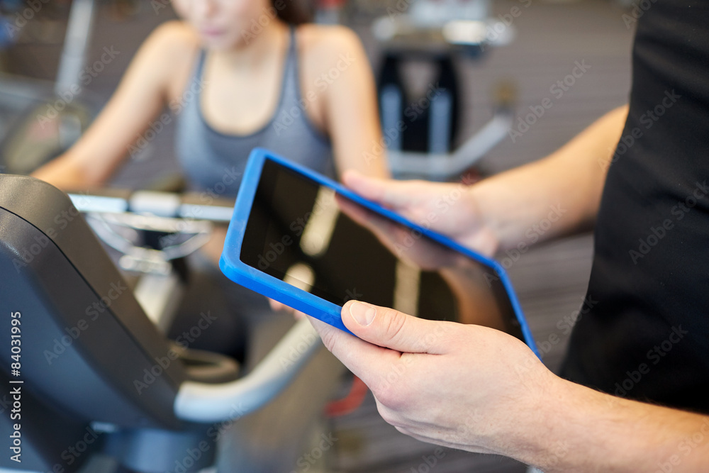 close up of trainer hands with tablet pc in gym close up of trainer hands with tablet pc in gym