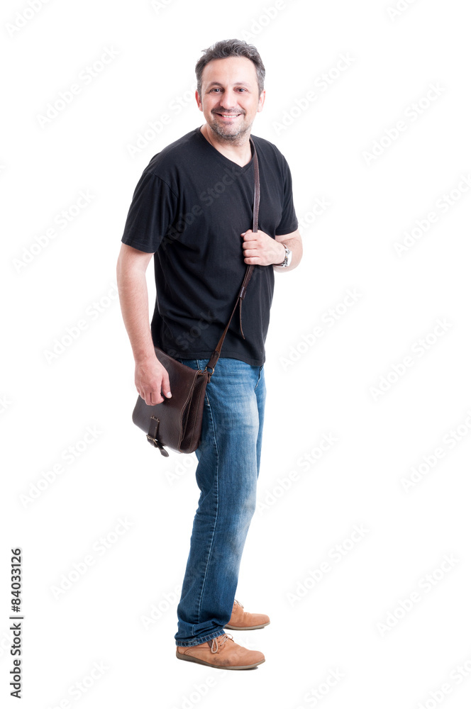 Adult male model wearing jeans, black t-shirt and bag Adult male model wearing jeans, black t-shirt and bag