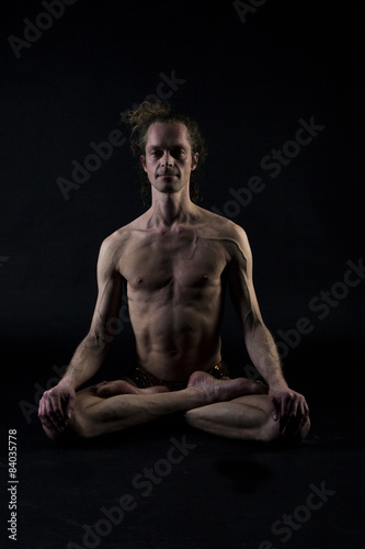 Young man practicing yoga © Anna Shelestova