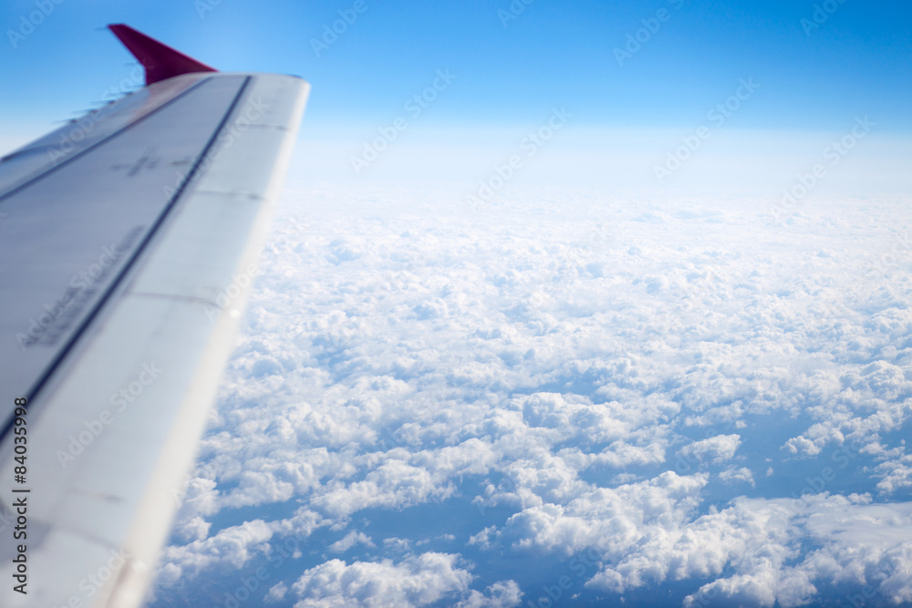Fototapeta premium Looking to clouds through airplane window