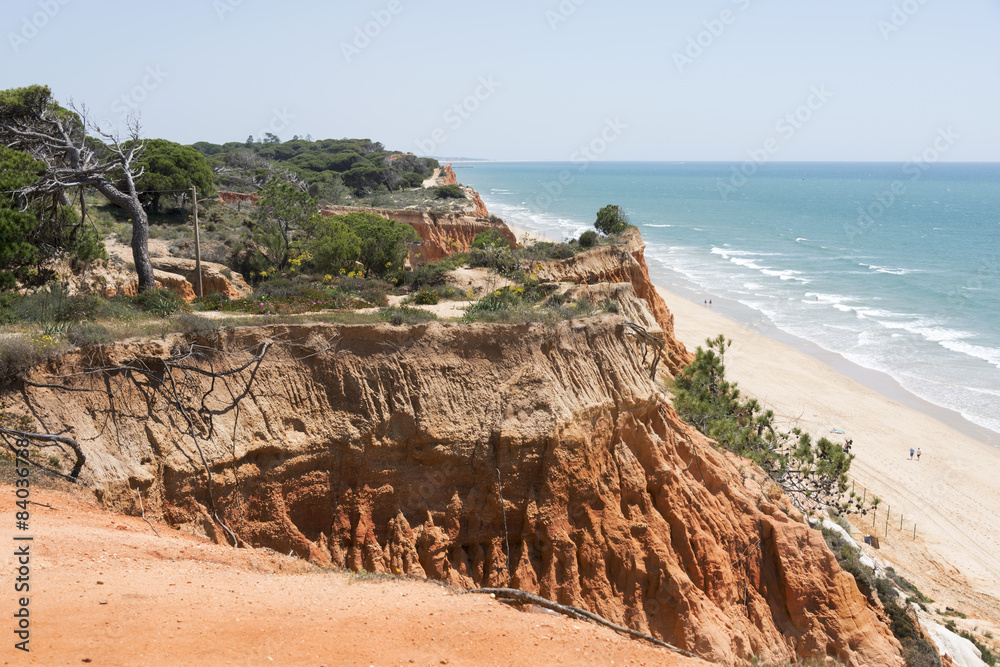people at the beach near Cliffs at Praia da Falesia