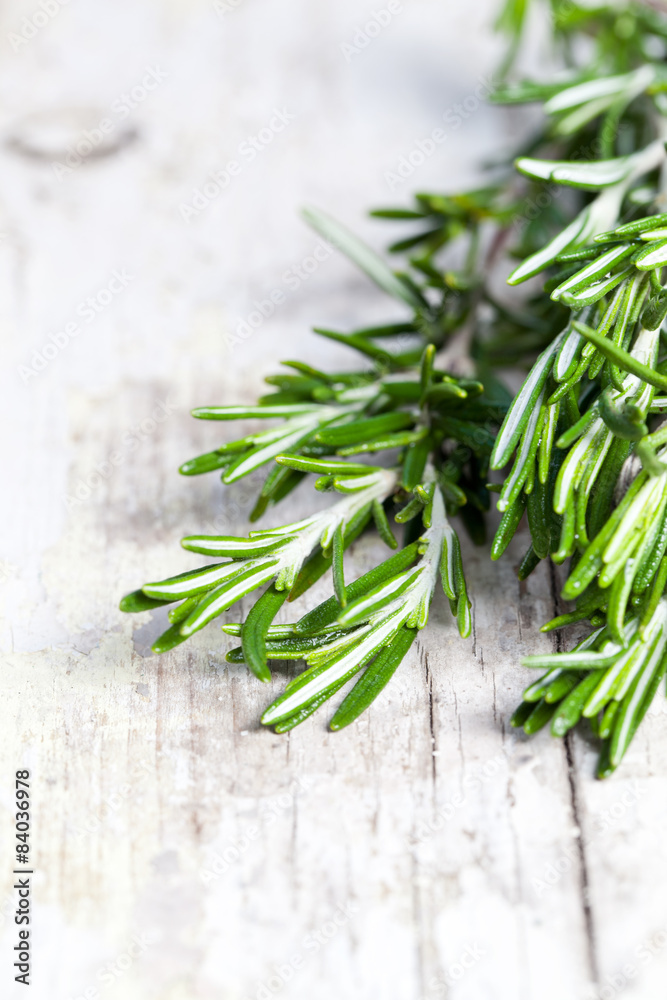 Bunch of fresh rosemary on a wooden background Bunch of fresh rosemary on a wooden background