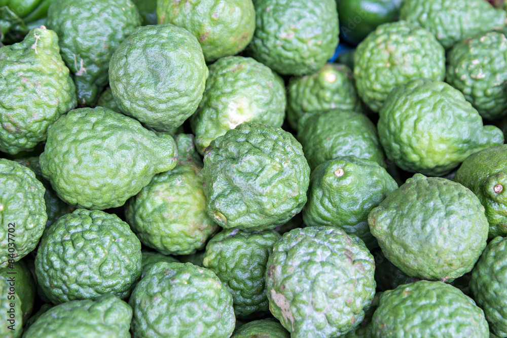 Heap of kaffir limes on market Heap of kaffir limes on market