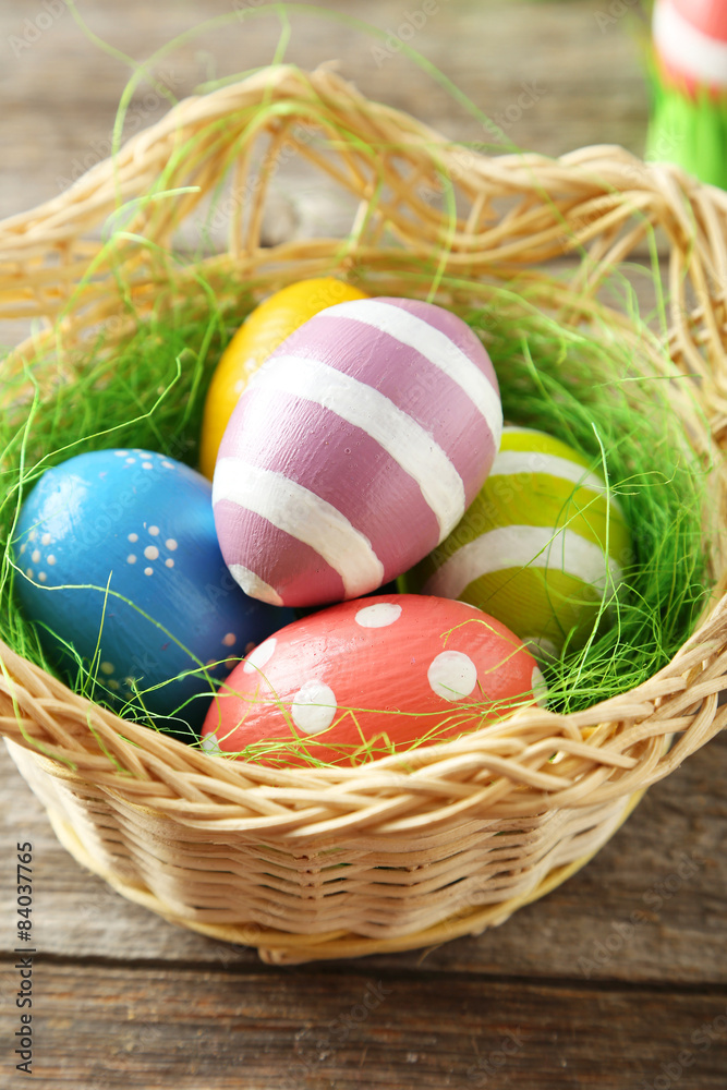 Easter eggs in basket on grey wooden background Easter eggs in basket on grey wooden background