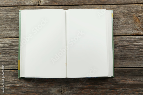 Open book on grey wooden background