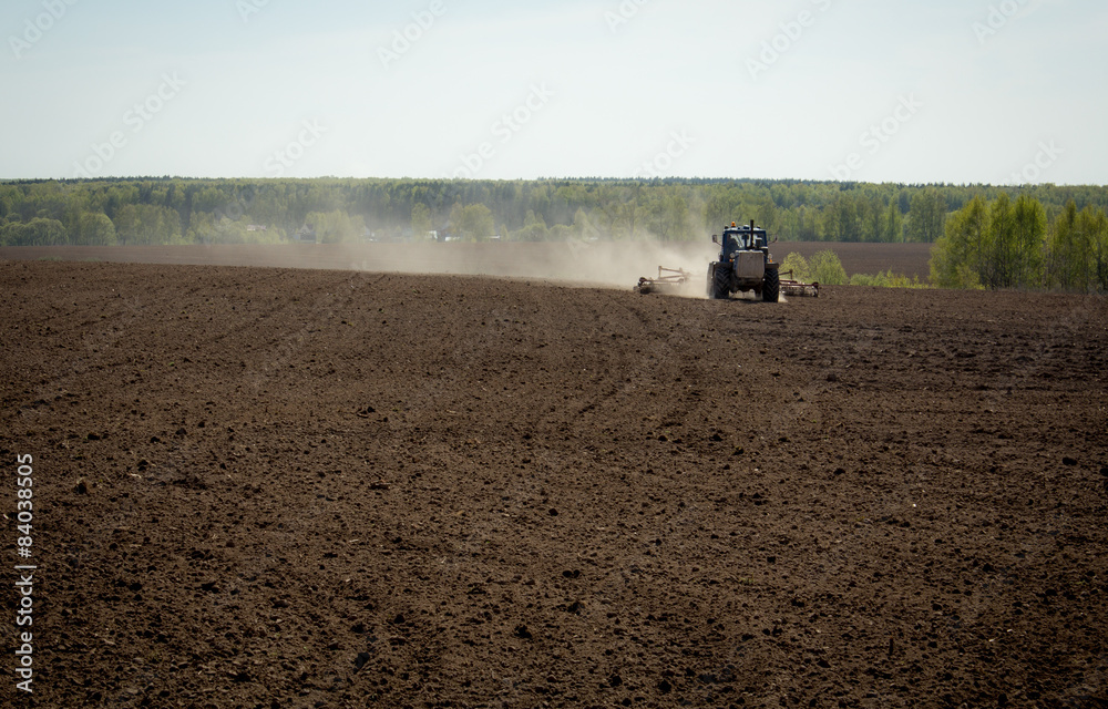 Fototapeta premium Tractor in plowed field