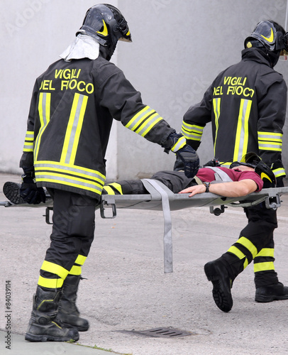 firefighters carried the injured away on stretchers