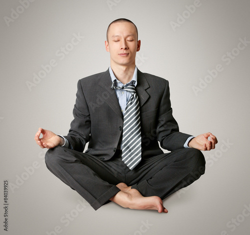 businessman in lotus pose meditating photo