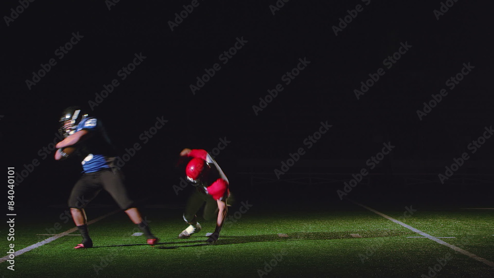 A football player running with the ball runs into and spins around a defender A football player running with the ball runs into and spins around a defender