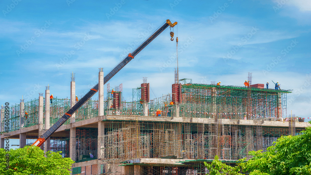 Crane and building construction site against blue sky Crane and building construction site against blue sky