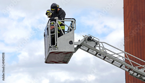 firefighters in the fire truck basket during the practice of tra