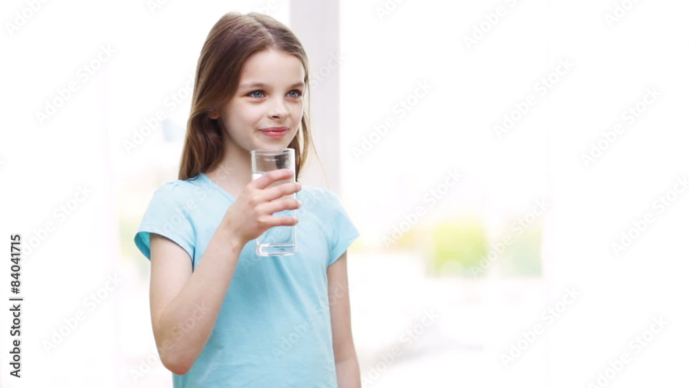 happy smiling little girl drinking water at home happy smiling little girl drinking water at home