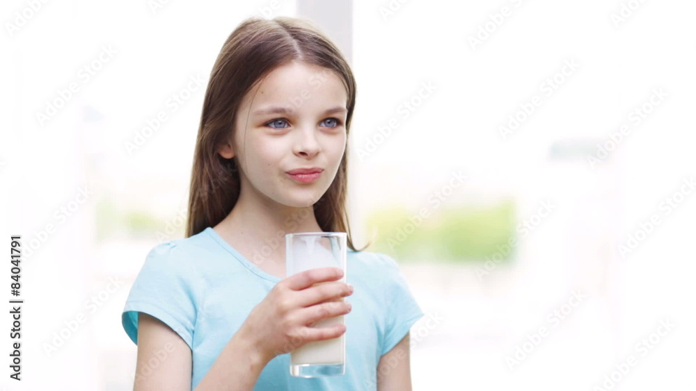 happy smiling little girl drinking milk at home happy smiling little girl drinking milk at home