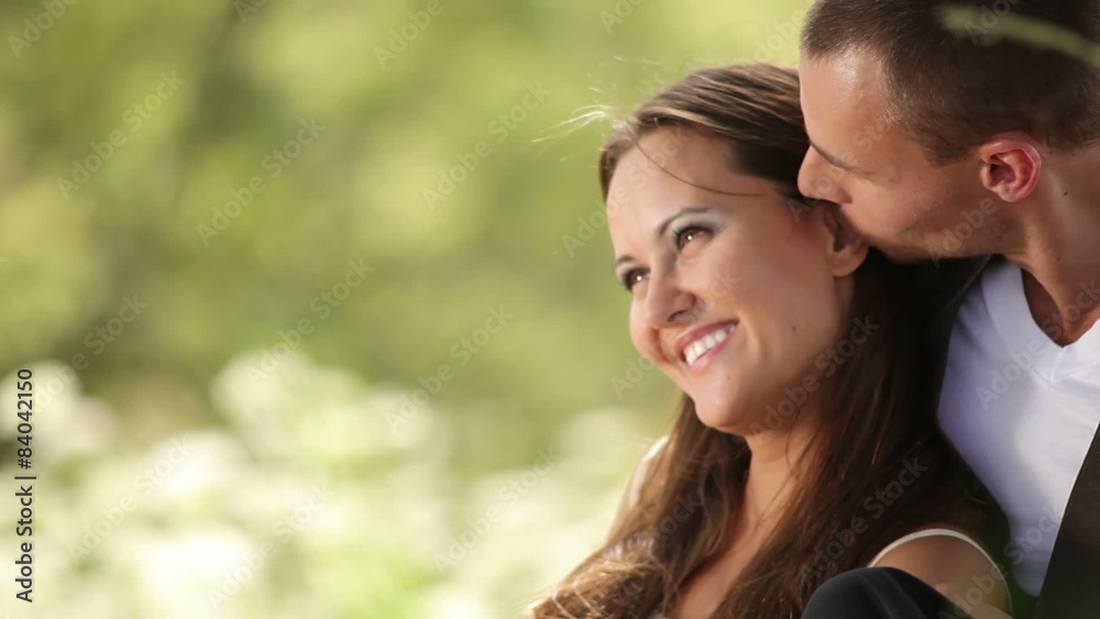 Young couple relax against a tree. Medium shot. Young couple relax against a tree. Medium shot.